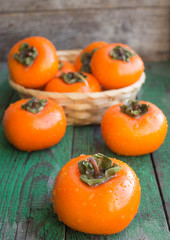 ripe persimmons in a wicker basket