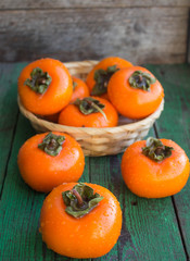 ripe persimmons in a wicker basket