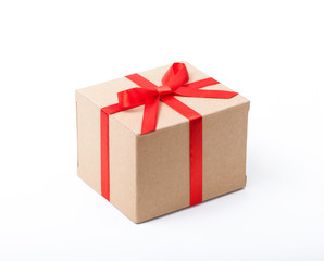 Festive gift. Beige box and red satin bow.