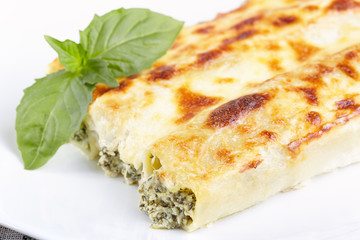 Cannelloni with spinach and ricotta baked in sauce bechamel