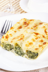 Cannelloni with spinach and ricotta baked in sauce bechamel