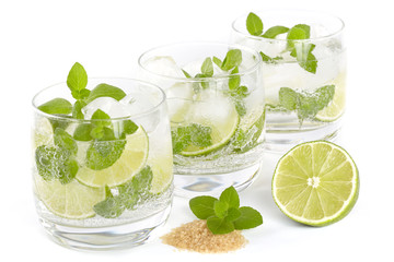 Three glasses with Mojito cocktail on a white background