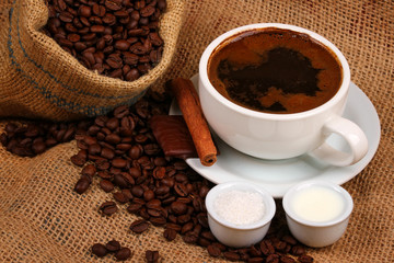 Fresh cup of black coffee with milk and sugar
