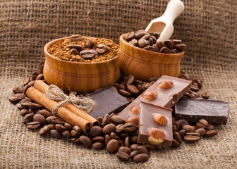 Coffee beans in wooden bowl on burlap tablecloth, rustic style