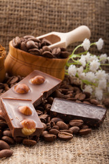 Coffee beans in wooden bowl on burlap tablecloth, rustic style