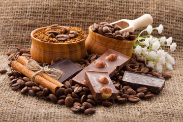Coffee beans in wooden bowl on burlap tablecloth, rustic style