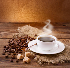 Coffee cup and saucer on  wooden table.