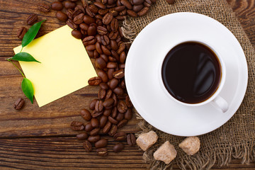 Coffee cup and saucer on  wooden table.