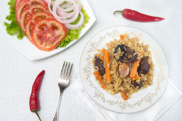 National pilau rice with beef served on a round plate