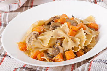 Pasta in cream sauce with slices of pumpkin and mushroom