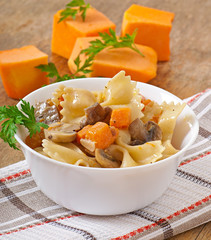 Pasta in cream sauce with slices of pumpkin and mushroom