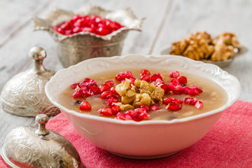 Turkish dessert Ashura, Noah's pudding, with pomegranate seeds and walnuts	