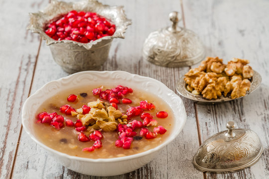 Turkish dessert Ashura with pomegranate, Noah's Pudding, served in White bowl