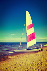 Fototapeta premium Sailboat on a beach. Vintage toned photo.