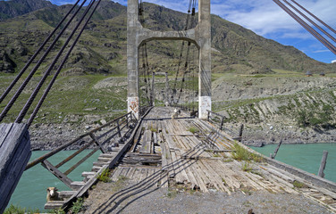 Abandoned bridge over the river Katun, Altai.