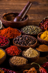 Variability of Asian spices on wooden table