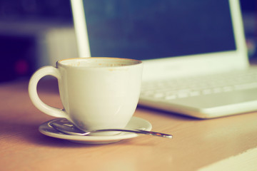 cup of coffee in coffee shop vintage color tone