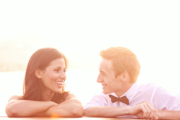 Bride and groom on a boat in Venice, loving each other sun