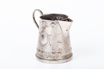 Old coffee pot without cover with spots of rust on a white backg