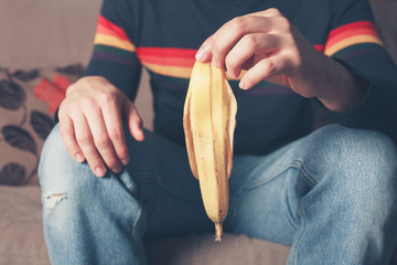 Young man with banana skin