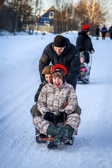 Fototapeta na wymiar young people fun sledding