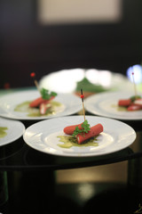 Sausages canape with pesto sauce