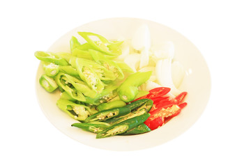 pepper and onion slices on a plate in isolate on white.