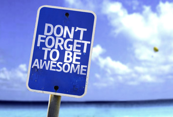 Don't Forget to Be Awesome sign with a beach on background