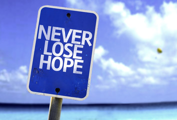 Never Lose Hope sign with a beach on background - obrazy, fototapety, plakaty