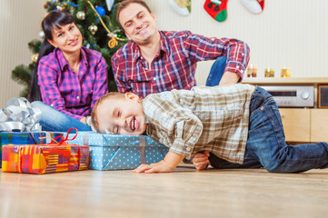 Little boy finds a Christmas presents under the tree