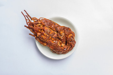 close up of a bowl of tamarind paste  on white background