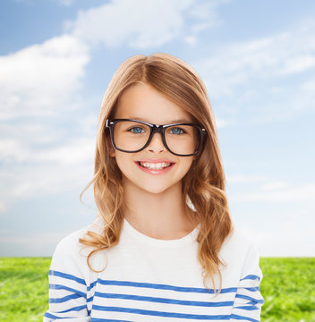 smiling cute little girl with black eyeglasses