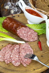 sausages on a wooden plate with vegetables in a restaurant
