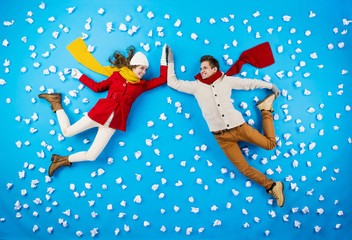 Young couple in winter studio having fun