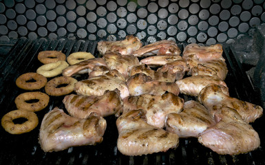 cooking chicken wings on a grill in the restaurant