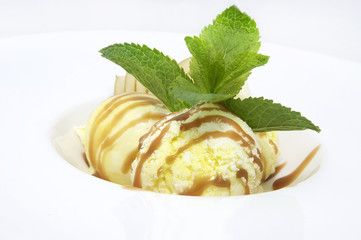 balls of ice cream with fruit and caramel sauce