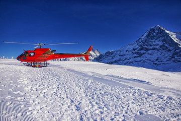 Red helicopter at swiss alps ski resort near Jungfrau mountain © Roman Babakin
