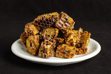 Pile of bee pollen or bee bread on the dark background