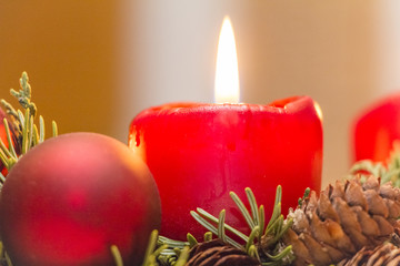 Shining red christmas candle in an advent wreath