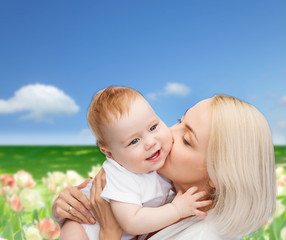 happy mother kissing smiling baby