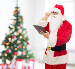 man in costume of santa claus with tablet pc