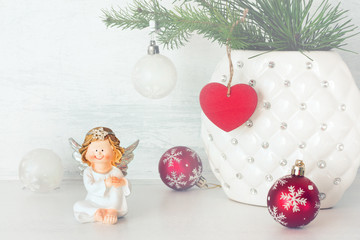 Cheerful angel and Christmas balls.