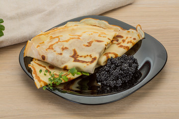Pancakes with black caviar
