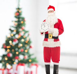 man in costume of santa claus with clock