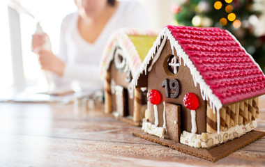 close up of woman making gingerbread houses