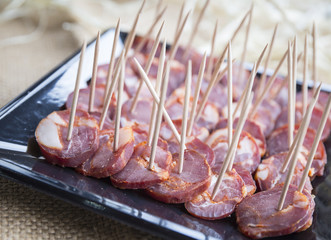 sliced chorizo sausage with toothpicks