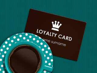 coffee with loyalty card lying on tablecloth