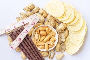 Seeds, peanuts and Potatoes fries in the plate isolated on white