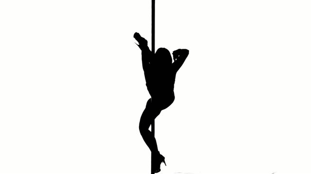 One caucasian woman pole dancer dancing in silhouette studio