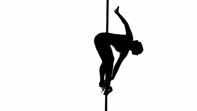 One caucasian woman pole dancer dancing in silhouette studio